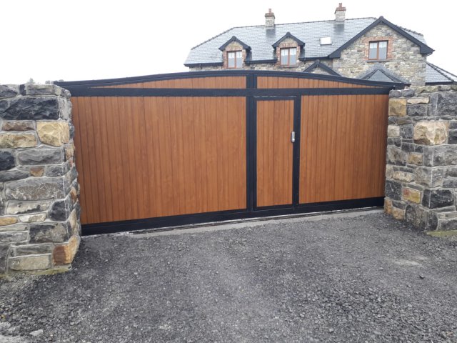 belvedere sliding gate with pedesrian door golden oak